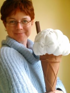 a woman in glasses holding an ice cream cone