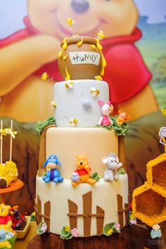 a winnie the pooh themed birthday cake