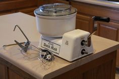 a white mixer sitting on top of a kitchen counter