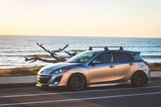 a car parked on the side of the road near the ocean