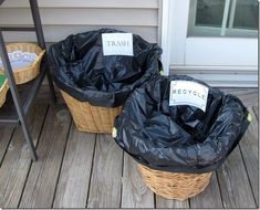 two trash bags sitting on top of a wooden deck