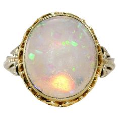 14K Yellow Gold Australian Opal Ring, 2.80ct, 4g Ladies Australian crystal opal ring with 14k yellow gold setting. Stamped 14k and weighs 4 grams gross weight. The opal is a solid piece and measures 14.5 x 12.3 x 2.8mm, approximately 3.00 carats. Very attractive blue and green color flashes from every angle. No cracks or scratches. Scroll design on the sides of the ring. Ring size is 5 and can be sized up to a 6 for an extra fee. Excellent condition. Luxury Timeless Yellow Gold Opal Ring, Australian Opal Ring, Crystal Opal, Yellow Gold Setting, Scroll Design, Opal Ring, Opal Crystal, Australian Opal, Ring Ring