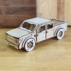 a toy truck made out of wood sitting on a table