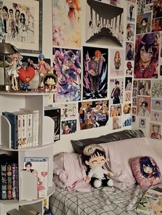 a bed room with a neatly made bed and lots of pictures on the wall