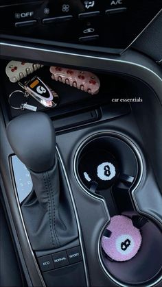 the interior of a car with buttons and steering wheel knobs on it's center console