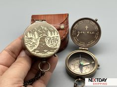 a hand holding a compass and a pocket watch with the words you are on it