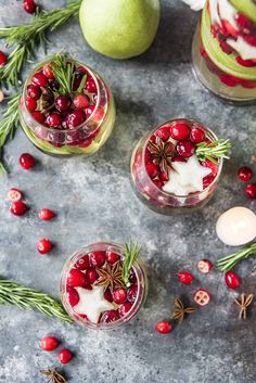 two glasses filled with cranberry pomegranate and topped with cinnamon star anise