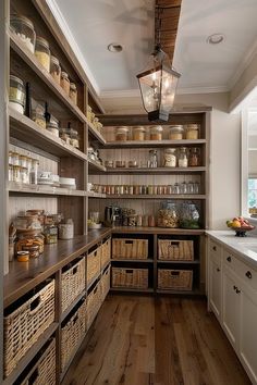 a kitchen filled with lots of wooden shelves and wicker baskets on top of it