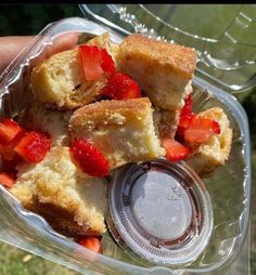 a person holding a plastic container filled with food