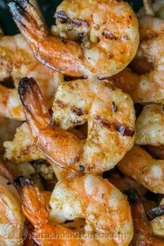 grilled shrimp and shrimp skewers are piled on top of each other