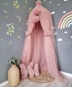 a pink canopy bed in a child's room