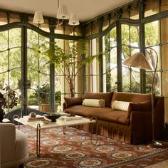 a living room filled with furniture and lots of windows