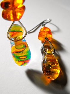 "This pair of earrings is just one in a collection of one-of-a-kind fused dichroic glass earrings created by Bryan Northup. Using techniques originated over years of working with fused glass, each pair is a one-of-a-kind, hand-wired adornment that displays a wide variety of vivid color combinations that change color in differing light conditions. This listing is for the pair pictured. Check out my other designs in the shop.   A variety of lengths are available but most are 1\", 1.5\" up to 2\" long glass pieces plus the ear wire   Each earring is wired by hand and in some cases augmented with accent beads.  The ear wire is either surgical steel or sterling silver See all photos for a full description. Handmade by Bryan Northup Objects are stored in a clean, non-smoking space.  Made in Oak Iridescent Glass Earrings For Gift, Yellow Fusion Earrings For Gifts, Yellow Fusion Style Earrings For Gift, Art Jewelry Earrings, Fused Glass Panel, Dichroic Glass Jewelry, Dichroic Glass Earrings, Art Glass Jewelry, Character Flaws