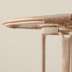 a close up view of the top of a wicker table with two bamboo poles attached to it