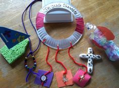 paper plate crafts and craft supplies laid out on a wooden table with the word jesus written on it