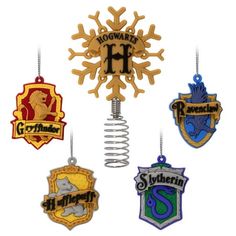 the hogwarts crest ornaments are hanging from hooks and hang on clothes pegs