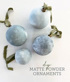 three blue and white ornaments with green stems