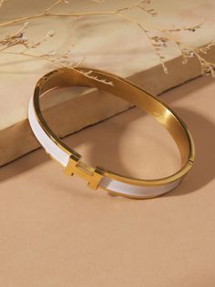 Embrace timeless elegance with this delicate gold bangle. This bracelet will make a cherished addition to your everyday style. Fall School, Bow Bracelet, Bangles Making, Beauty And Grace, Indian Culture, Stacked Jewelry, Bangle Designs, Bronze Gold, Cross Bracelet