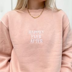 Reach out and find your Happily Ever After ✧ Our vintage pigment-dyed sweatshirts are so comfy and lightweight, you won't want to take it off and you'll have it for years! Now in a spring dusty pink/peach color, this crewneck is embroidered for a subtle, monochromatic design so you can wear the magic wherever you are, any day. This sweatshirt has an oversized fit. Model is 5'5" and wearing a size medium. Features 80% ring spun cotton, 20% polyester blend 100% cotton 30 singles face yarn split st Spring Washed Crew Neck Sweatshirt, Spring Washed Crew Sweatshirt, Trendy Pink Sweatshirt For Everyday, Trendy Pink Sweatshirt, Trendy Pink Everyday Sweatshirt, Pink Crew Sweatshirt With Embroidered Graphics, Cute Pink Embroidered Sweatshirt, Casual Pink Sweatshirt With Embroidered Text, Pink Long Sleeve Sweatshirt With Embroidered Text