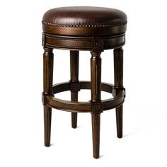 an upholstered stool with a brown leather seat