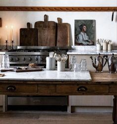 an old fashioned kitchen with many items on the counter