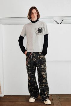 The Camo Frayed Cargo pants flawlessly merge military elements with street style. These pants feature an all-over camouflage print and frayed hem, giving them a rugged and edgy look. Side pockets sewn mid-leg enhance the practical design while adding a distinct aesthetic appeal. Crafted from premium fabric, these slightly oversized cargo pants are perfect for those seeking a blend of functionality and fashion in their everyday wardrobe. All-over camouflage print Mid-leg side pockets Frayed hem P Grunge Cargo Pants For Spring Streetwear, Spring Grunge Cargo Pants For Streetwear, Spring Grunge Streetwear Cargo Pants, Spring Military Cargo Pants For Streetwear, Spring Military Style Cargo Pants For Streetwear, Spring Combat Cargo Pants For Streetwear, Spring Camouflage Pants For Streetwear, Urban Camouflage Pants For Fall, Urban Camouflage Bottoms For Fall