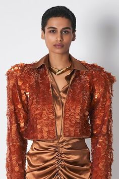 Rust structured jacket featuring embroidery in different sequin size and padded shoulder. - Aza Fashions Designer Embroidered Fitted Outerwear, Designer Embellished Outerwear For Festive Season, Designer Embellished Festive Outerwear, Designer Festive Embellished Outerwear, Designer Embroidered Blazer For Fall, Designer Party Outerwear With Lapel Collar, Designer Festive Evening Outerwear, Luxury Fitted Sequin Outerwear, Fall Party Outerwear With Embroidery