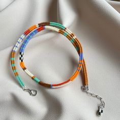 multicolored beaded bracelet on white fabric