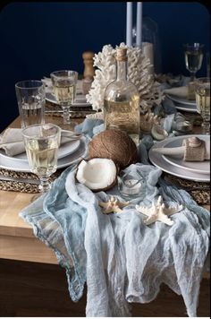 the table is set with dishes and glasses