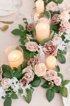 the table is set with candles and flowers