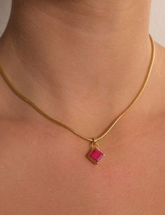 BEHIND THE DESIGN This piece features a square gemstone with a bezel setting. It is rotated 45 degrees to give this oblique/diamond shaped look and paired with Bonito's signature top double ring which fits perfectly through our best-selling Snake Chain or any other Bonito chain. DETAILS Gemstone: 1cm square pendant featuring a natural Red Ruby gemstone Chain: 18ct Gold Vermeil Snake Chain (50cm+5cm extension) This piece contains natural materials and is handcrafted which may vary slightly in col Square Cut Diamond Jewelry Gift, Modern Jewelry With Bezel Setting And Square Cut, Modern Square Cut Bezel Set Jewelry, Ruby Necklace Pendant, Ruby Pendant, Square Pendant, Ruby Stone, Double Ring, Ruby Gemstone