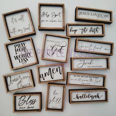 twelve framed wooden signs with names and phrases on them, all in different sizes or shapes