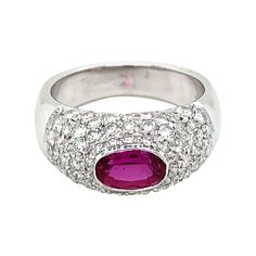 A timeless design Diamond band ring set in 18k white gold, it features a vivid natural oval Ruby in the center, weight 1.10 carat, surrounded by 1.50 carats of Sparkling Round brilliant cut diamond, graded G Color VS clarity, pavé setting. When worn there is not a spot on this band without a diamond showing. CONDITION: Excellent METAL: 18k Gold GEM STONE: Ruby 1.10 ct. Diamond 1.50 total carats RING SIZE: US 7/7.5 - IT 15 - FR 55 - UK O, Resizable on request, free of charge WEIGHT: 8 grams * the Classic White Oval Ruby Ring, White Oval Ruby Ring, Oval White Ruby Ring, Oval Diamond Ring With Pave Setting In Platinum, Oval Platinum Diamond Ring With Pave Setting, Oval Ruby Ring With Vvs Clarity Diamond, Dazzling Oval Ruby Ring In White Gold, Dazzling Oval White Gold Ruby Ring, Color Diamond Ring