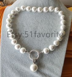 Elegant White Shell Necklace For Wedding, Elegant White Shell Necklace, Pearl White Shell Necklace For Wedding, Elegant Wedding Shell Necklace With Pearl Charm, Elegant Silver Round Beads Shell Necklace, Elegant White Round Shell Necklace, Elegant Silver Shell Necklace With Round Beads, Pearl White Shell-shaped Pearl Necklace As A Gift, Pearl White Shell-shaped Necklaces For Beach