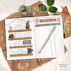 an open notebook with some plants on top of it next to a pair of scissors