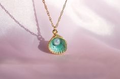 🌊 🐚 In the heart of an underwater kingdom, a green oyster pendant with a shimmering pearl was discovered. This necklace brings a touch of ocean magic and mermaid charm to your everyday style. ✨ 🎁 Your order will arrive in a pre-packaged special and cute box. Ready to be gifted to yourself or someone you care about! 🔍 DETAIL * Material: High quality of Gold Plated Brass * Chain Length: 40 +5 cm / 15.75 +1.95 inches (At the chain's end there is a + 5cm/1.9 inch extension) 📦 SHIPPING * Our pro Ocean-inspired Pearl Pendant Jewelry, Ocean-inspired Pearl Charm Jewelry As Gift, Ocean-inspired Pearl Charm Jewelry For Gifts, Ocean-inspired Pearl Charm Jewelry Gift, Ocean-inspired Shell-shaped Jewelry Gift, Ocean-inspired Pearl Pendant Necklaces As Gifts, Ocean-inspired Pearl Pendant Jewelry As Gift, Ocean-inspired Pearl Pendant Jewelry Gift, Green Shell-shaped Jewelry For Gifts