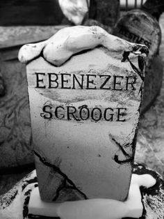 black and white photograph of a grave with the name ebenezer scrooge written on it