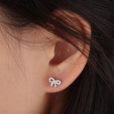 Check this cute bow stud out!!! Crafted in dazzling gems and made in stainless steel, can be wear everyday. Perfect for the lobe or helix, Tragus. That would be so cuteeee!! *For healed piercings* *﻿Customization availbale on post length and closure. Please refer to the following customization tap for more detail. Cute Silver Earrings With Bow, Cute Anniversary Jewelry With Bow, Diamond Bow Jewelry As Gift, Silver Cubic Zirconia Jewelry With Bow Detail, Silver Cubic Zirconia Jewelry With Bow, White Gold Bow Jewelry With Cubic Zirconia, White Gold Cubic Zirconia Jewelry With Bow Detail, White Gold Cubic Zirconia Jewelry With Bow, Cubic Zirconia Bow Jewelry Gift