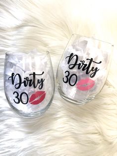 two wine glasses with the words dirty thirty and 30 printed on them, sitting next to each other