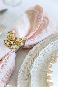 a close up of a napkin on a table with utensils and silverware