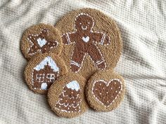 four gingerbread cookies are arranged on a bed