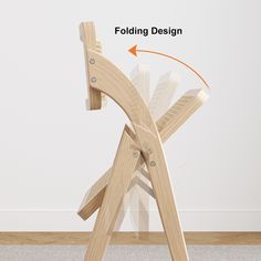 the folding chair is made out of wood and has an arrow pointing up at it