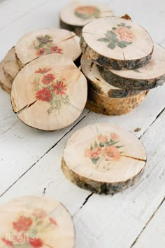 several pieces of wood that have been cut into slices with flowers painted on the top