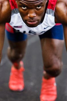 a man is doing push ups with his hands behind his head and feet on the ground