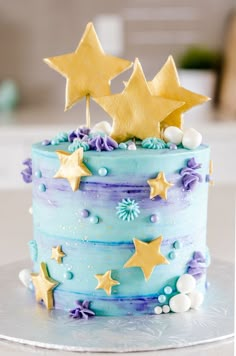 a blue and purple cake with stars on top