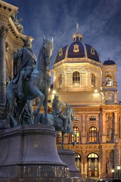 there is a statue in front of a building with a horse and rider on it