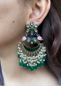 These beautiful Kundan earrings are the perfect accessory to brighten up your outfit. They are lightweight and high quality, and sure to become a staple in your jewellery collection.  Available in 3 beautiful colours: lilac purple, dark green and hot pink.  In case of any queries, please feel free to contact us. Happy shopping! Fusion Style Peacock Design Earrings For Wedding, Fusion Style Wedding Earrings With Peacock Design, Fusion Wedding Earrings With Peacock Design, Green Bridal Earrings For Party, Green Dangle Bridal Earrings For Festive Occasions, Bollywood Style Peacock Design Earrings For Party, Peacock Design Dangle Earrings For Wedding, Bollywood Style Peacock Earrings For Party, Bollywood Style Peacock Design Party Earrings