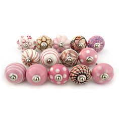 a bunch of pink and white ornaments sitting next to each other on a white surface