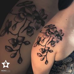 two women with tattoos on their arms, one has flowers and the other has leaves