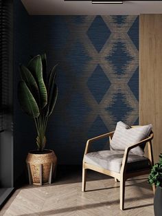 a chair and potted plant in front of a wall with geometric designs on it